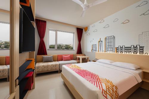 a bedroom with a bed and a couch at Ginger Faridabad in Faridabad