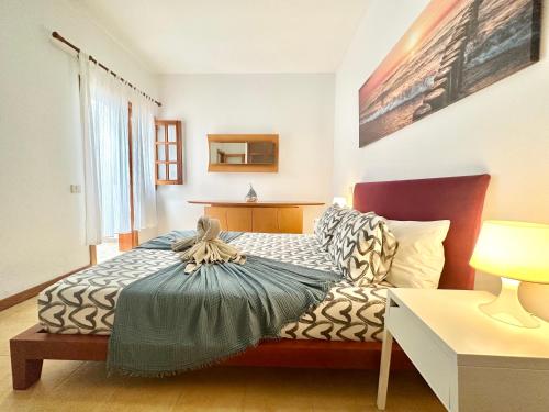 a bedroom with a bed and a table at Lima Limon by Lovely property in Cotillo