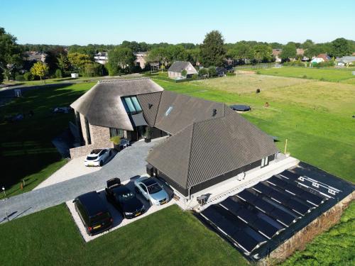 an overhead view of a house with cars parked in front at La Vita Veluwe in Wapenveld