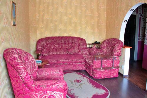 a living room with a couch and a chair at Рэдиссон in Petropavlovsk