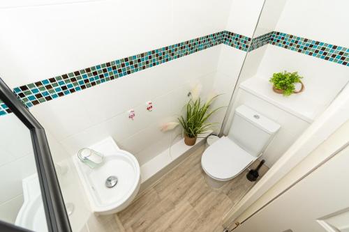 a bathroom with a toilet and a sink at Fife - Driveway Parking Spacious 4 bed house Sleeps 6 Ideal Contractor Accommodation in Gateshead