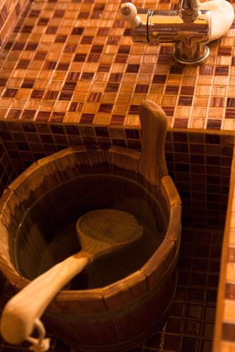 a wooden toilet in a bathroom with a wooden spoon at Alexandros Palace in Ouranoupoli