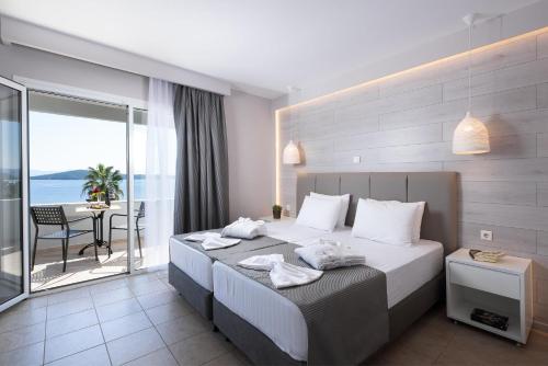a hotel room with a bed and a balcony at Alexandros Palace in Ouranoupoli