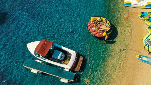 two boats on the water next to a beach at Alexandros Palace in Ouranoupoli