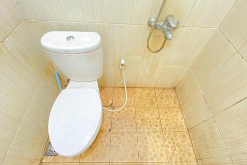 a bathroom with a toilet and a shower at RedDoorz Syariah @ Jalan Jendral Sudirman Pekanbaru in Pekanbaru