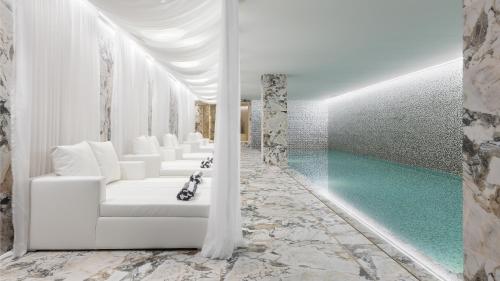 a living room with a white couch and a pool at Wine & Books Porto Hotel in Porto
