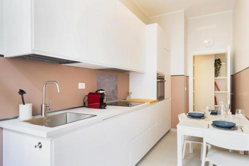 a kitchen with a sink and a counter top at Easylife - Luminosa dimora in Sant'Ambrogio in Milan