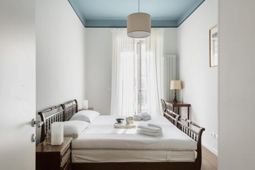 a bedroom with two beds and a window at Easylife - Luminosa dimora in Sant'Ambrogio in Milan