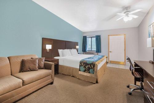 a hotel room with a bed and a couch at Baymont by Wyndham Keystone Near Mt. Rushmore in Keystone