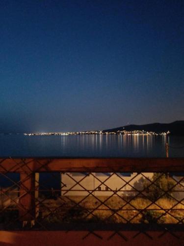 a view of a body of water at night at Calma in Perdika