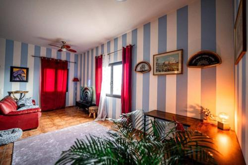 a living room with blue and white striped walls at Art Apartment Ticino in Vacallo