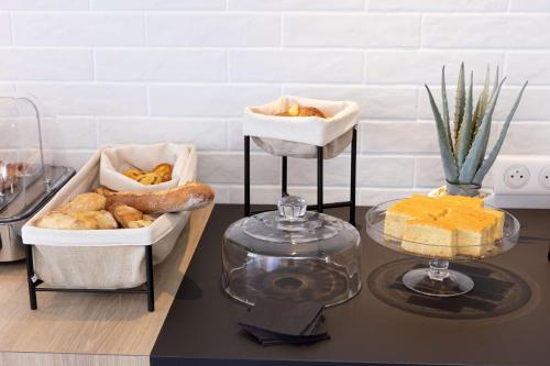 a table with two trays of bread and pastries at Hilton Garden Inn Tours Centre, France in Tours