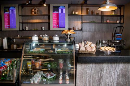 a restaurant with a counter with bread and food at Camino Real Fashion Drive Monterrey in Monterrey