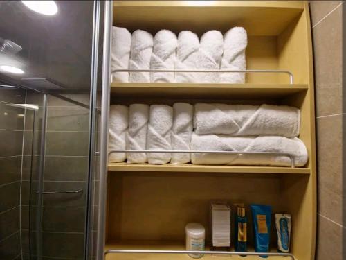 a towel rack with towels and towels in a bathroom at Best Travel in Haeundae with best location in Busan