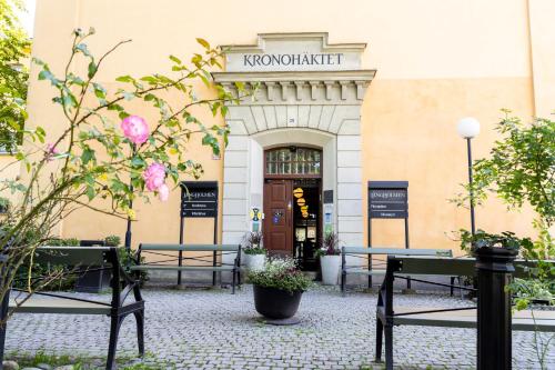 a building with benches in front of a building at Långholmen Hotell in Stockholm