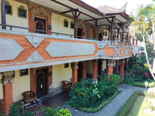 a building with a balcony on the side of it at Hotel Grand Kumala Bali in Legian