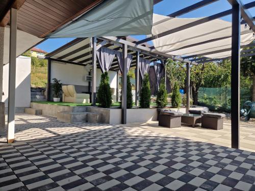 a patio with a black and white checkered floor at Private house in Vaslui