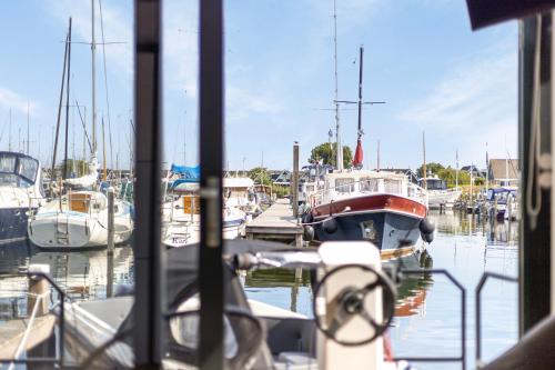a group of boats docked in a marina at Cosy tiny houseboats near beach and restaurants by Weltevreden Experience in Zeewolde
