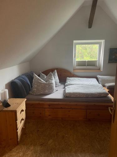 a bedroom with a wooden bed and a window at An der Bürgeheide in Finsterwalde