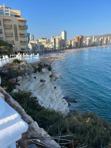 a view of a beach with buildings and the water at BENILOVE en PLAYA in Benidorm