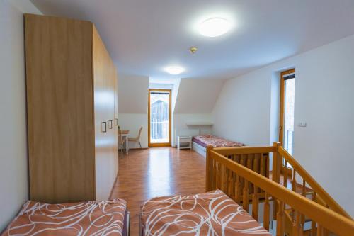 a room with two beds and a staircase at Hájenka Kozlov in Litomyšl