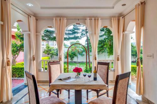 a dining room with a table and chairs at Arna Villa by VEO - Part of StayVista in Udaipur