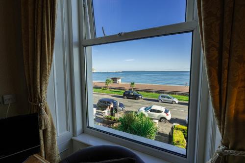 a window with a view of the ocean at Can-Y-Bae Hotel in Llandudno
