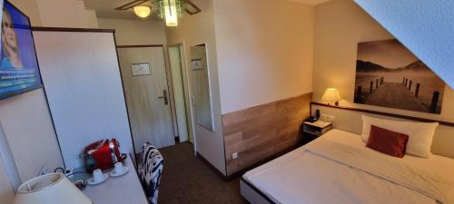 a hotel room with a bed and a bedroom with at Motel RL in Oberthulba