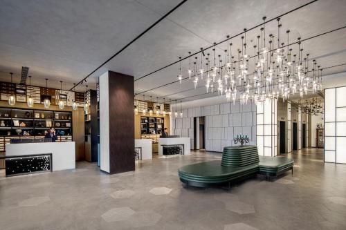 a lobby with a chandelier and a table and chairs at Four Points by Sheraton Shanghai Hongqiao in Shanghai