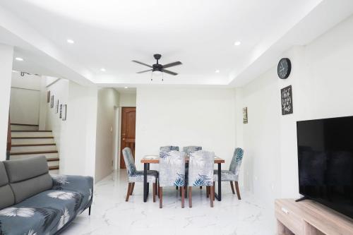 a living room with a table and chairs at Luxurious Place Mountain View Spacious with WIFI Near SM Lucena in Lucena