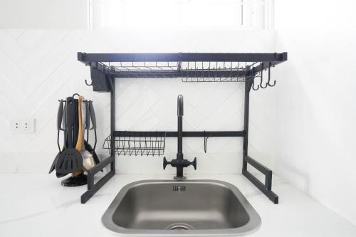 a kitchen sink with a shelf above it at Luxurious Place Mountain View Spacious with WIFI Near SM Lucena in Lucena