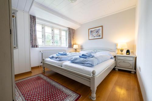 a bedroom with a bed with blue towels on it at Haus Amanda in Norddorf