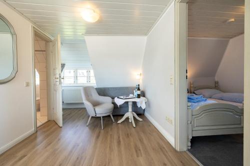 a small room with a table and a bed at Haus Amanda in Norddorf