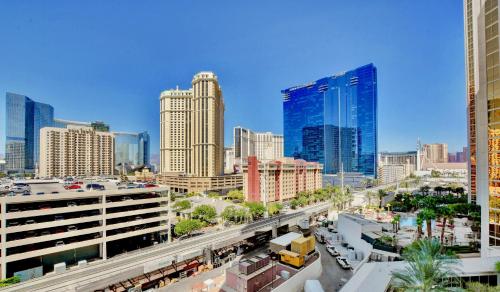 a city skyline with tall buildings and a train track at Strip View Balcony Suites - No Resort Fee ! in Las Vegas