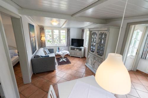 a living room with a couch and a tv at Haus Amanda in Norddorf