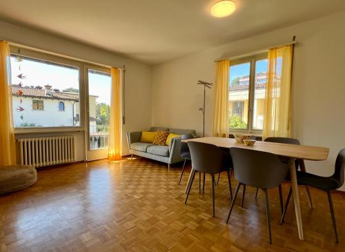 ein Wohnzimmer mit einem Tisch, Stühlen und einem Sofa in der Unterkunft Ascona Casa Farfalla 1 in Ascona