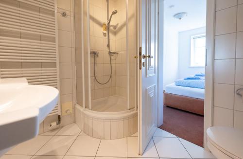 a bathroom with a shower and a sink at Haus Amanda in Norddorf