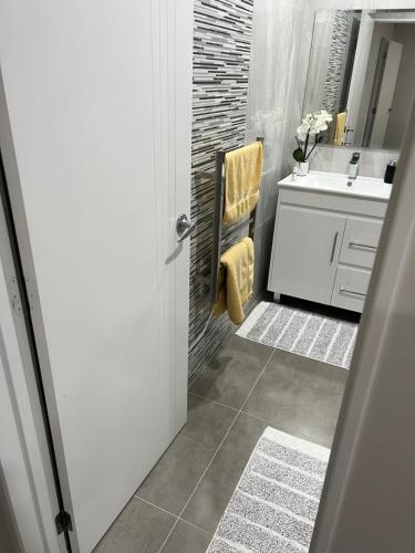 a bathroom with a sink and a toilet and a mirror at Private resident in Auckland