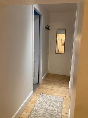 an empty hallway with a mirror and a rug at Maison de campagne 10 personnes. in Brizambourg