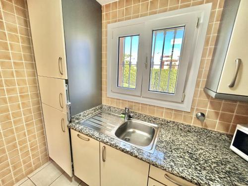 a kitchen with a sink and a window at Apartamento Teresa in Oliva