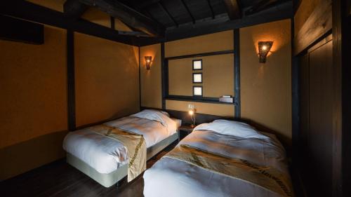 Cama o camas de una habitación en 森の入り江の離れ宿 無雙庵枇杷