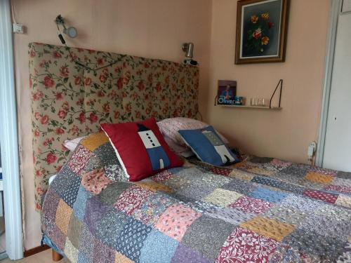a bedroom with a bed with a quilt on it at Vaskio-bed in Salo
