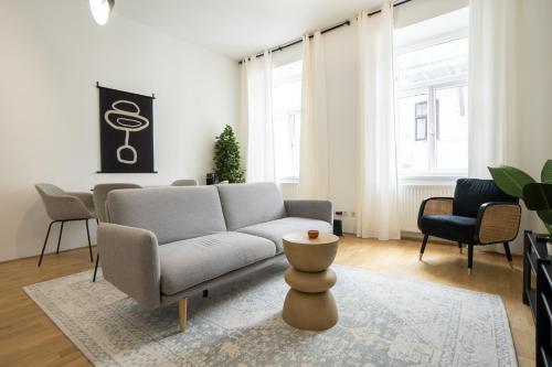 a living room with a couch and a table at Modern apartment in a top location of Vienna in Vienna
