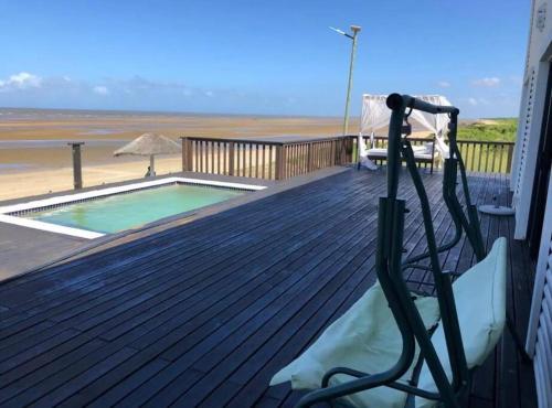 a deck with a swimming pool and a hose at Casa da Praia Catembe in Maputo