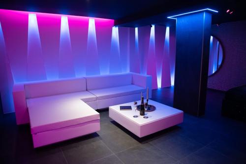 a living room with a couch and a table at LES SECRETS ROOMS - BONNEVILLE - LOVE ROOM 130m2 - SPA PRIVATIF in Bonneville