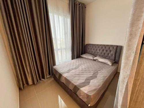 a small bed in a room with a window at 1 Room Studio @ MKH Boulevard 2 in Kajang