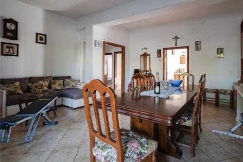 a living room with a wooden table and chairs at Casa Belvedere in Foiano della Chiana