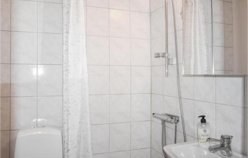 a white bathroom with a shower and a sink at Nice Home In Ystad With 0 Bedrooms in Ystad