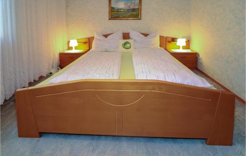 Nice Home In Pulkau With Kitchen في Pulkau: سرير كبير في غرفة النوم ومصباحين