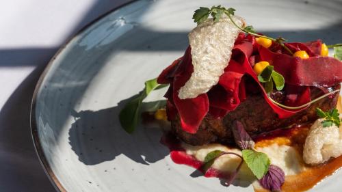a white plate with a piece of food on it at Crowne Plaza Hawkesbury Valley by IHG in Windsor